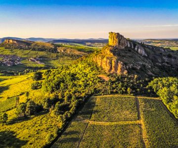 The limestone rocks of Solutré (foreground) and Vergisson (background, left) overlook the Mâconnais vineyards in south Burgundy, France.